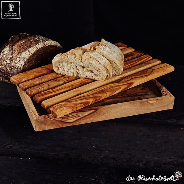 Bread cutting board out of olive wood with a practical crumb box